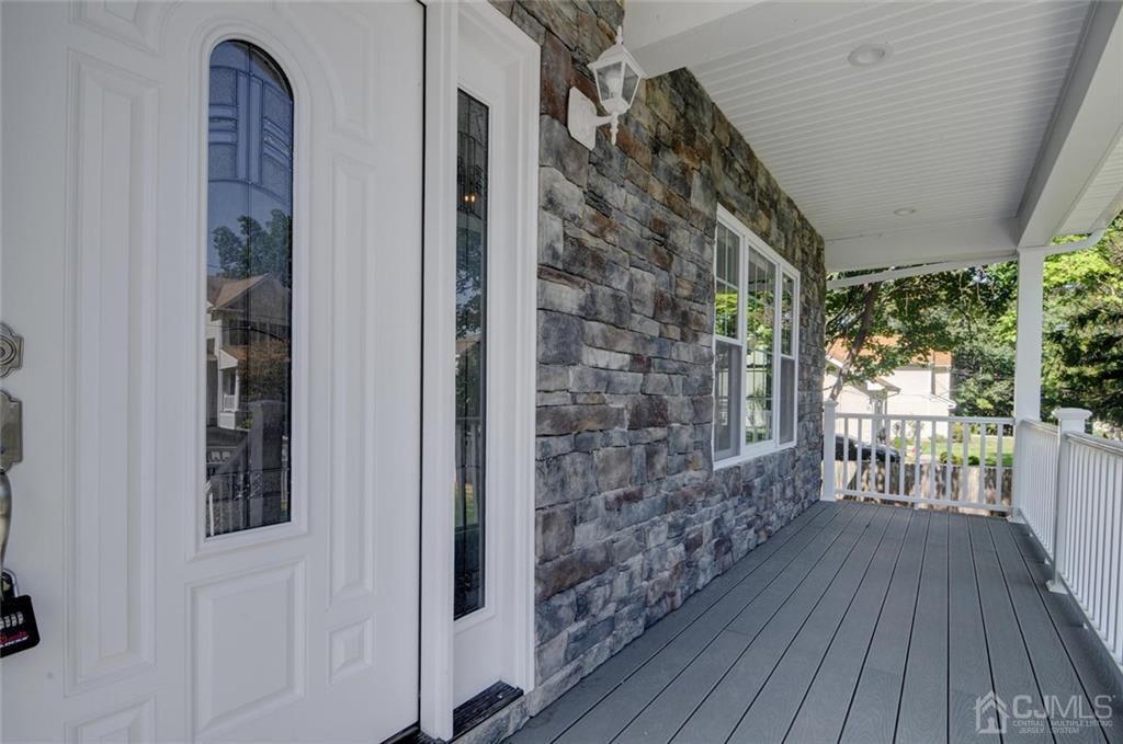 127 North Hill Road Colonia, NJ 07067 - Photo 6 of 40 a view of a porch with wooden floor and a floor to ceiling window