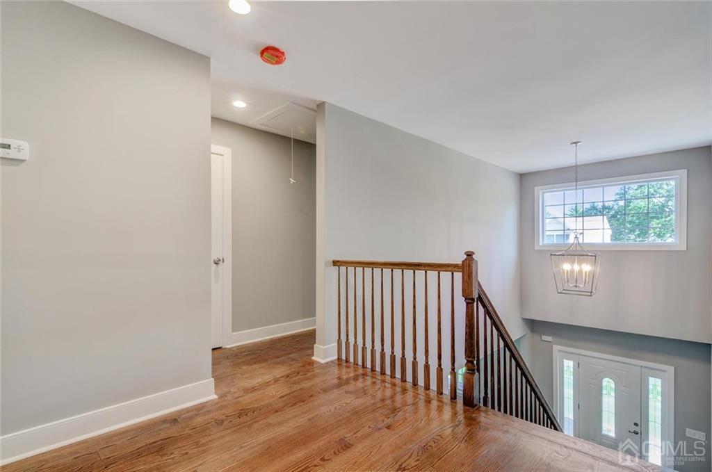 127 North Hill Road Colonia, NJ 07067 - Photo 10 of 40 a view of a hallway with wooden floor and windows