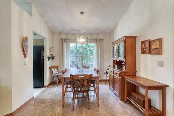 a kitchen with stainless steel appliances granite countertop a refrigerator and a stove