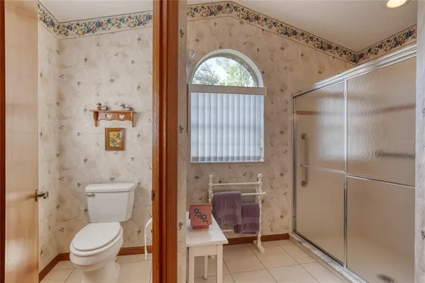 a bedroom with a bed and a table in it with window