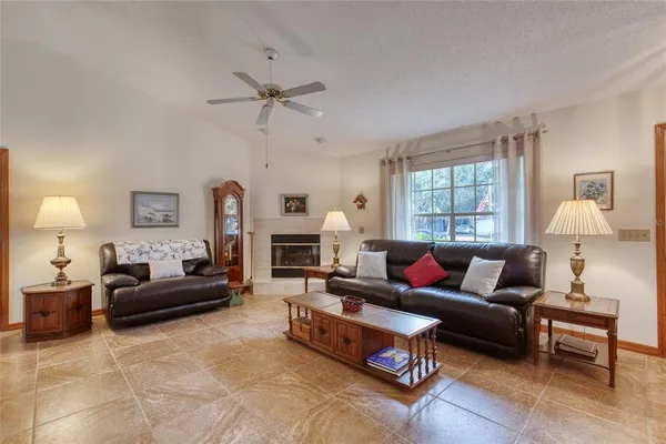 a living room with furniture fireplace and a window