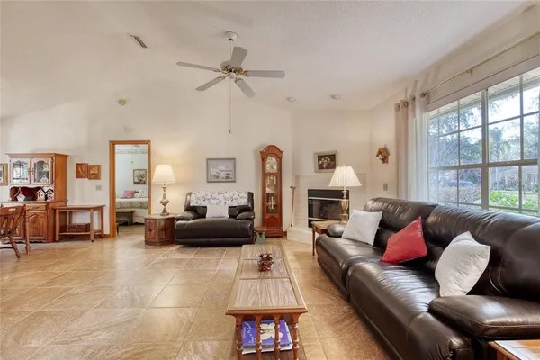 a living room with furniture a rug and a window