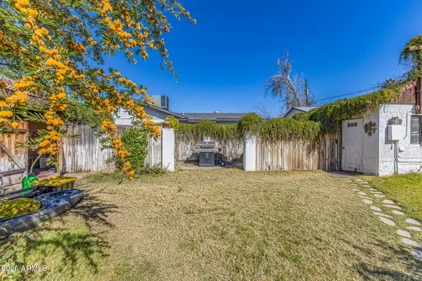 a front view of a house with a yard and tree