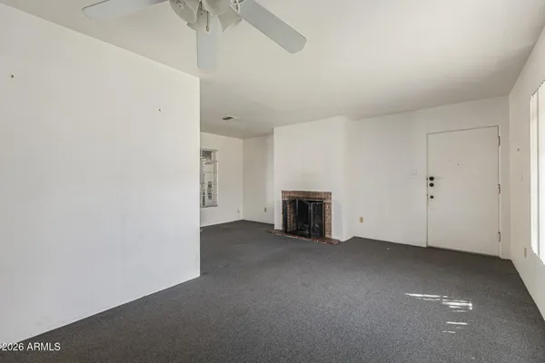 a view of empty room with a fireplace