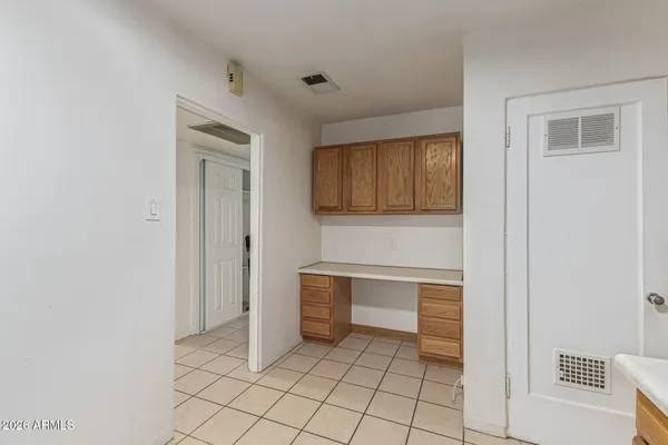 a view of an empty room with window and cabinet