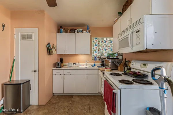 a kitchen with a sink stove and cabinets