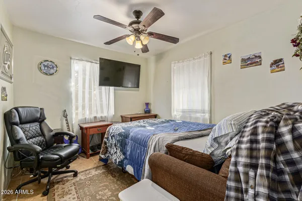 a bedroom with a bed couch and a window