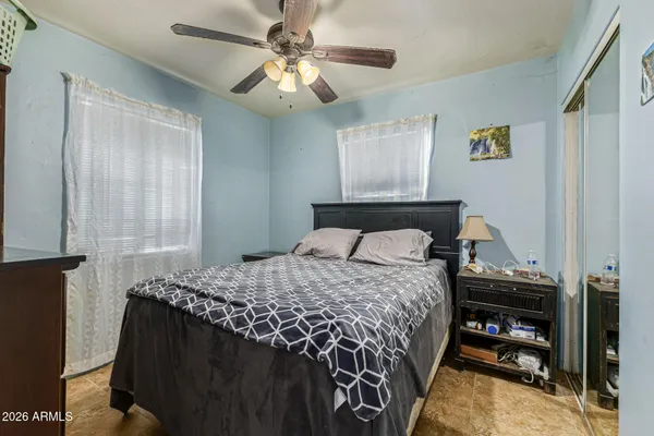 a bedroom with a bed and a chandelier