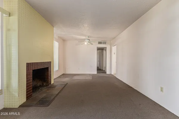 a view of an empty room with a fireplace