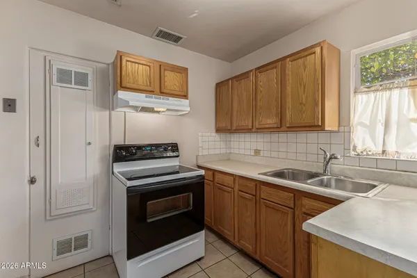 a kitchen with stainless steel appliances a stove sink and cabinets