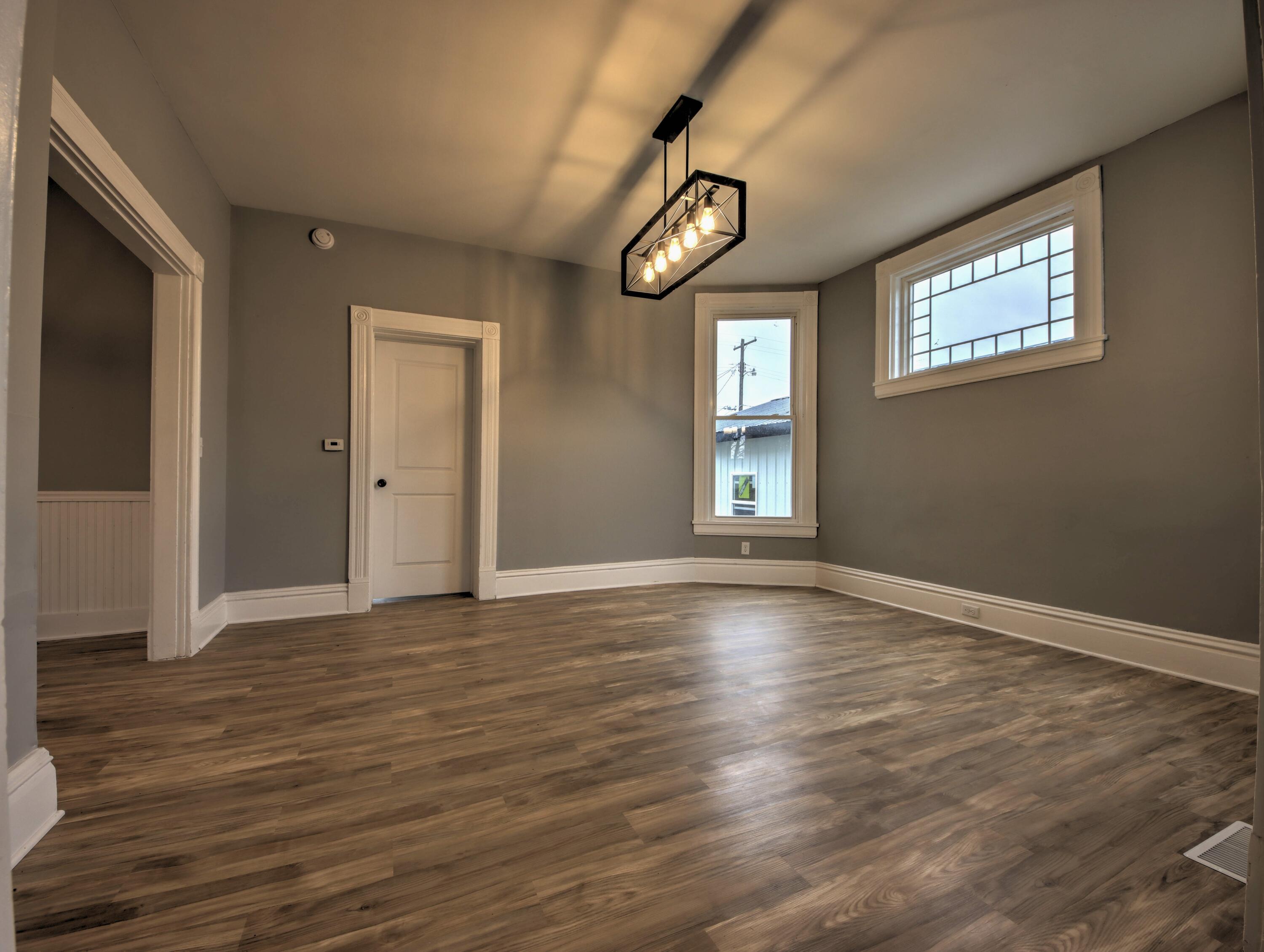 1005 Harrison Street La Porte, IN 46350 - Photo 11 of 54 a view of an empty room with wooden floor and a window
