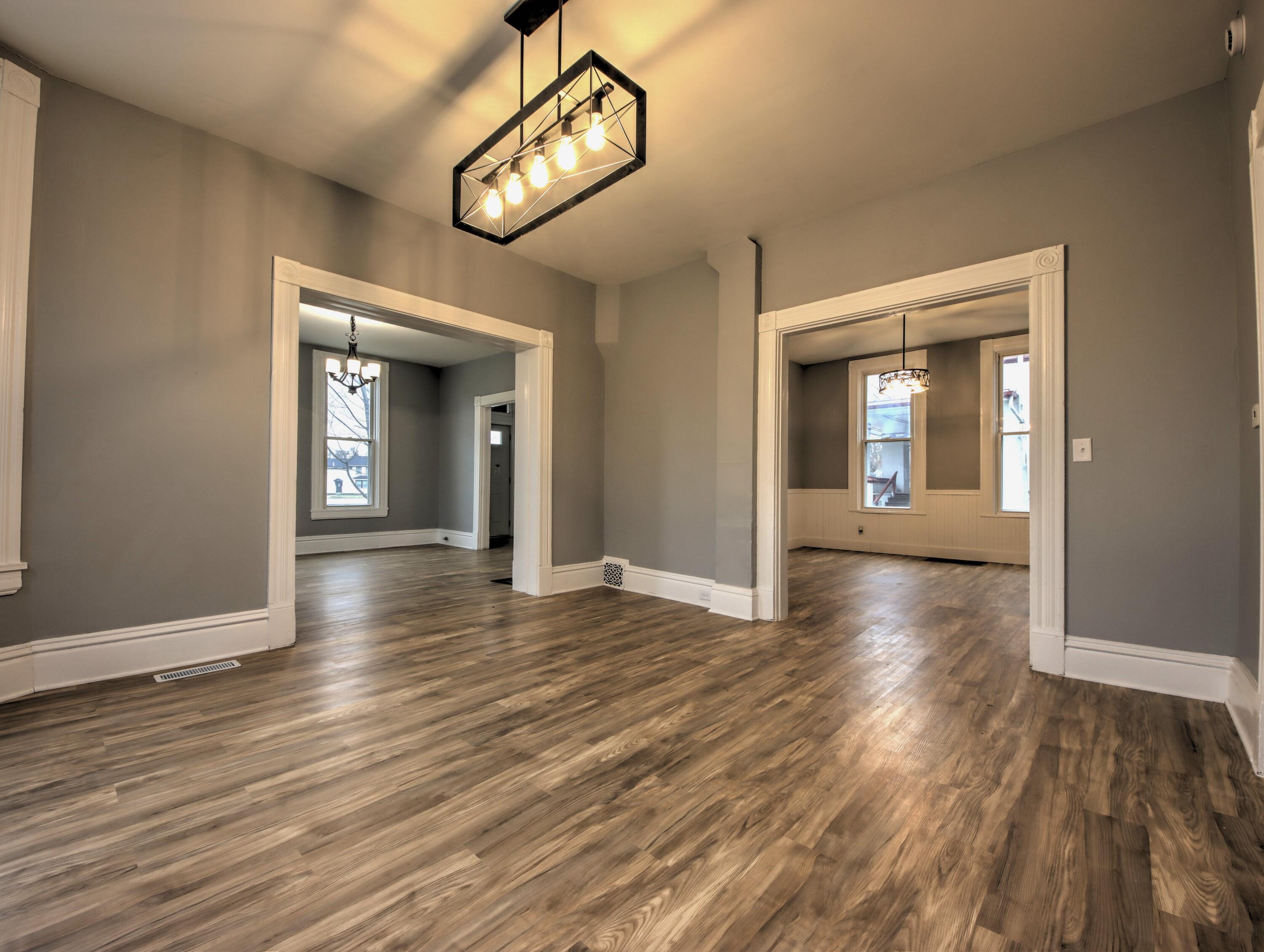1005 Harrison Street La Porte, IN 46350 - Photo 12 of 54 a view of a hallway with wooden floor and a chandelier