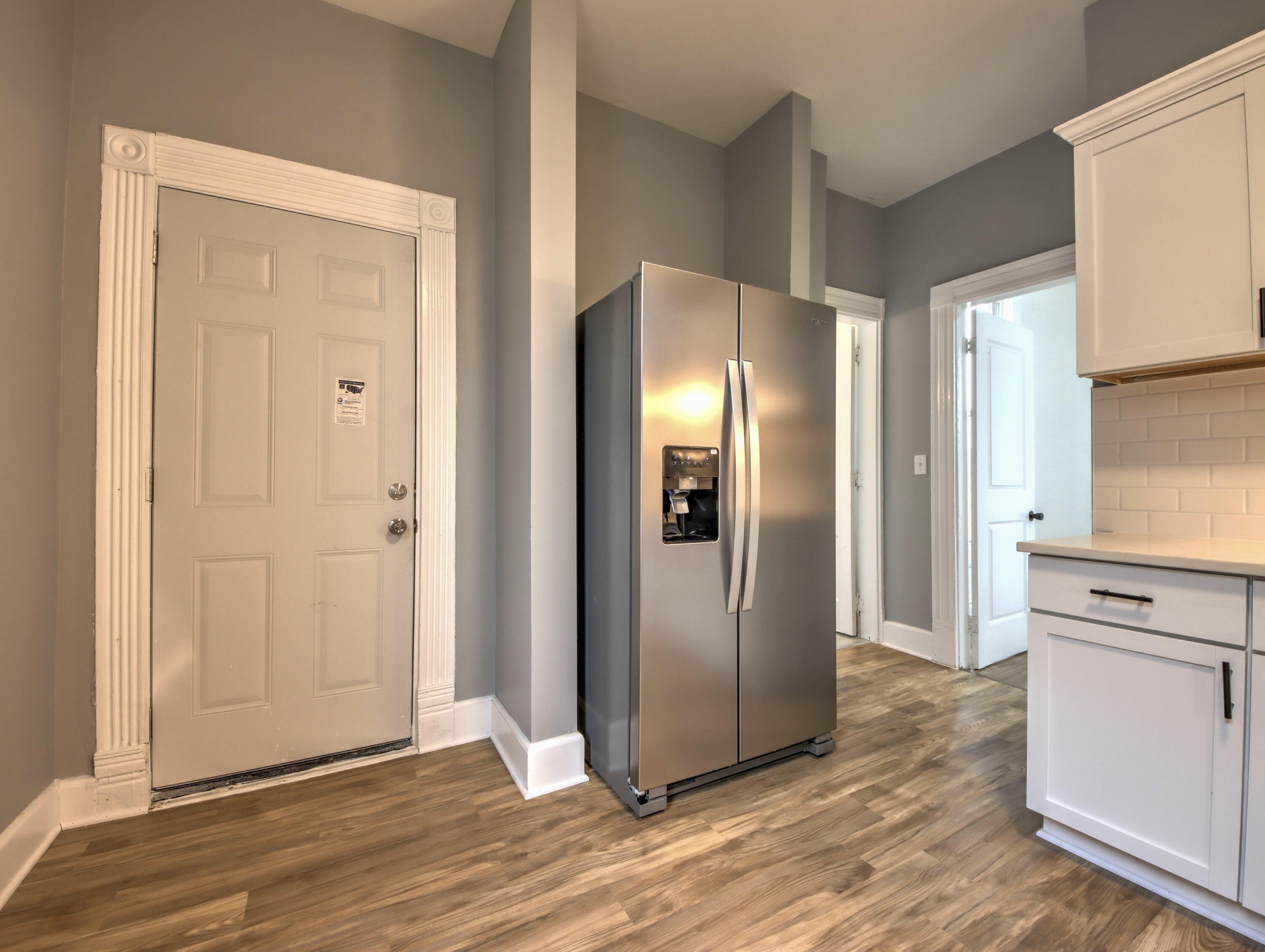 1005 Harrison Street La Porte, IN 46350 - Photo 16 of 54 a view of a kitchen with wooden floor and a refrigerator