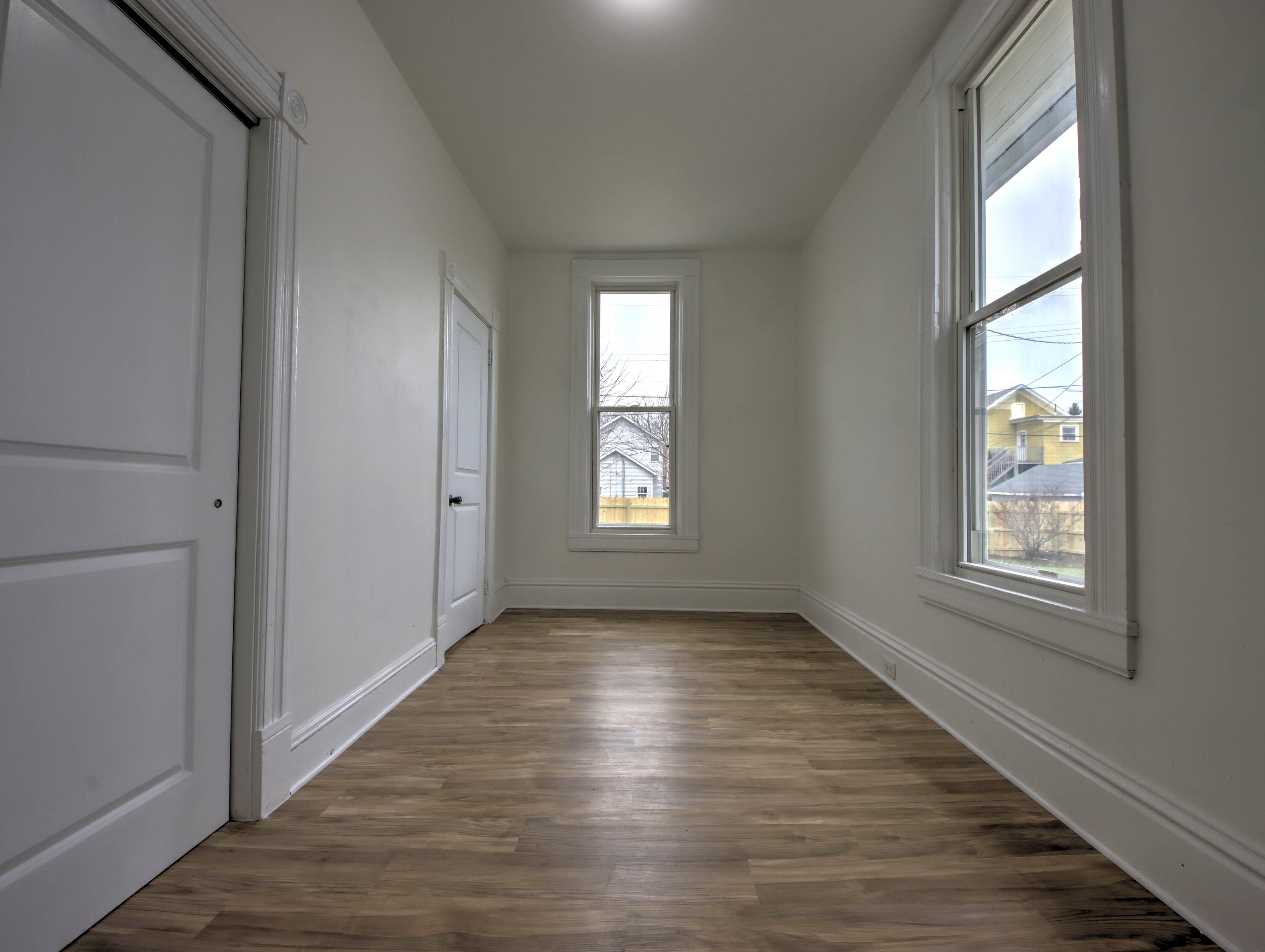 1005 Harrison Street La Porte, IN 46350 - Photo 19 of 54 a view of an empty room with wooden floor and a window
