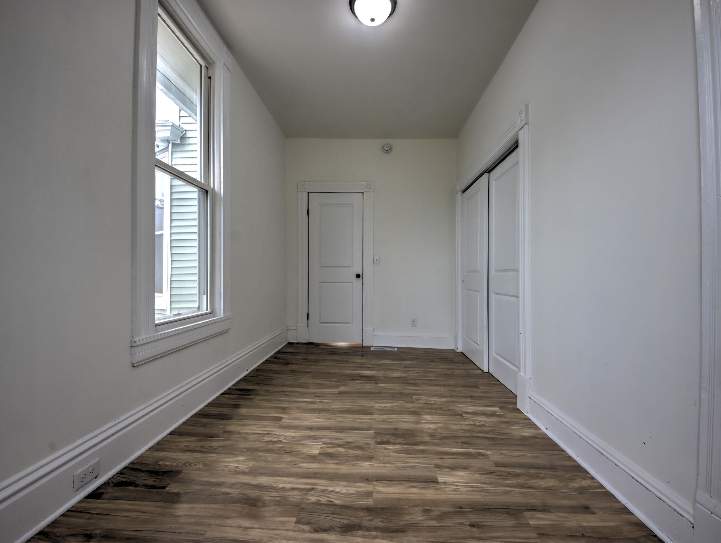 1005 Harrison Street La Porte, IN 46350 - Photo 20 of 54 a view of an empty room with wooden floor and a window