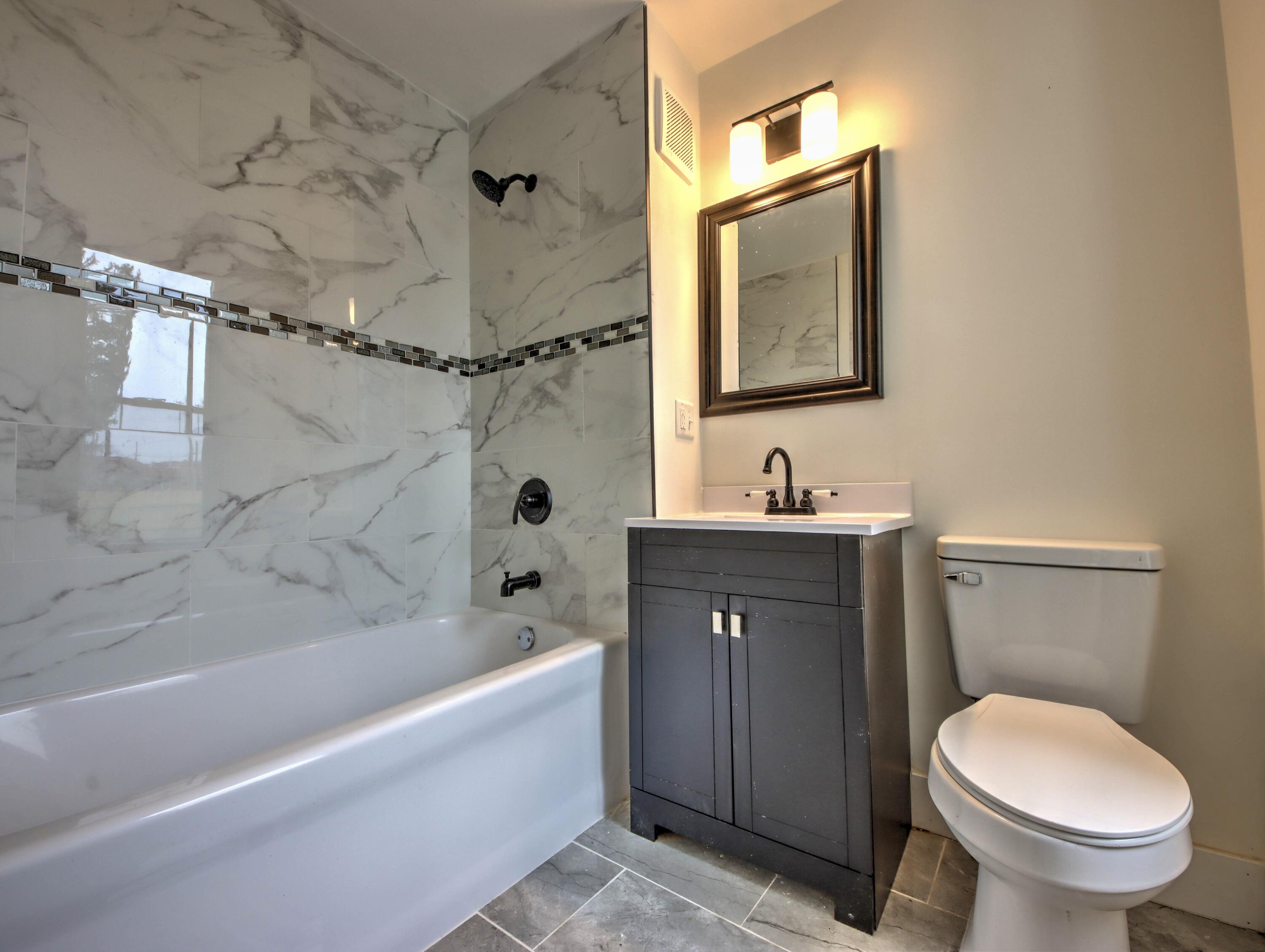 1005 Harrison Street La Porte, IN 46350 - Photo 21 of 54 a bathroom with a granite countertop sink toilet and shower