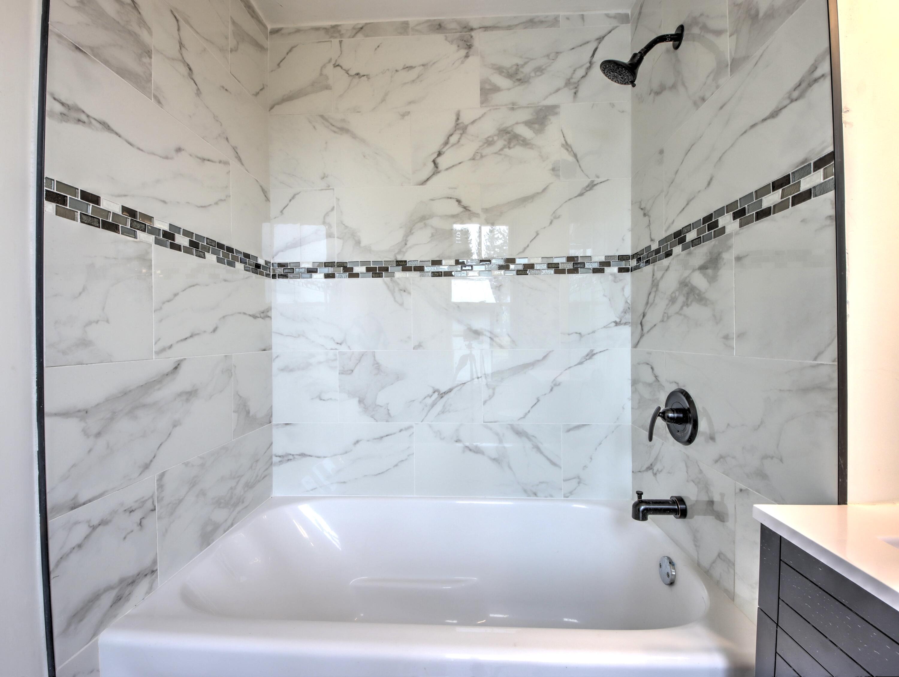 1005 Harrison Street La Porte, IN 46350 - Photo 23 of 54 a white bath tub sitting next to a shower