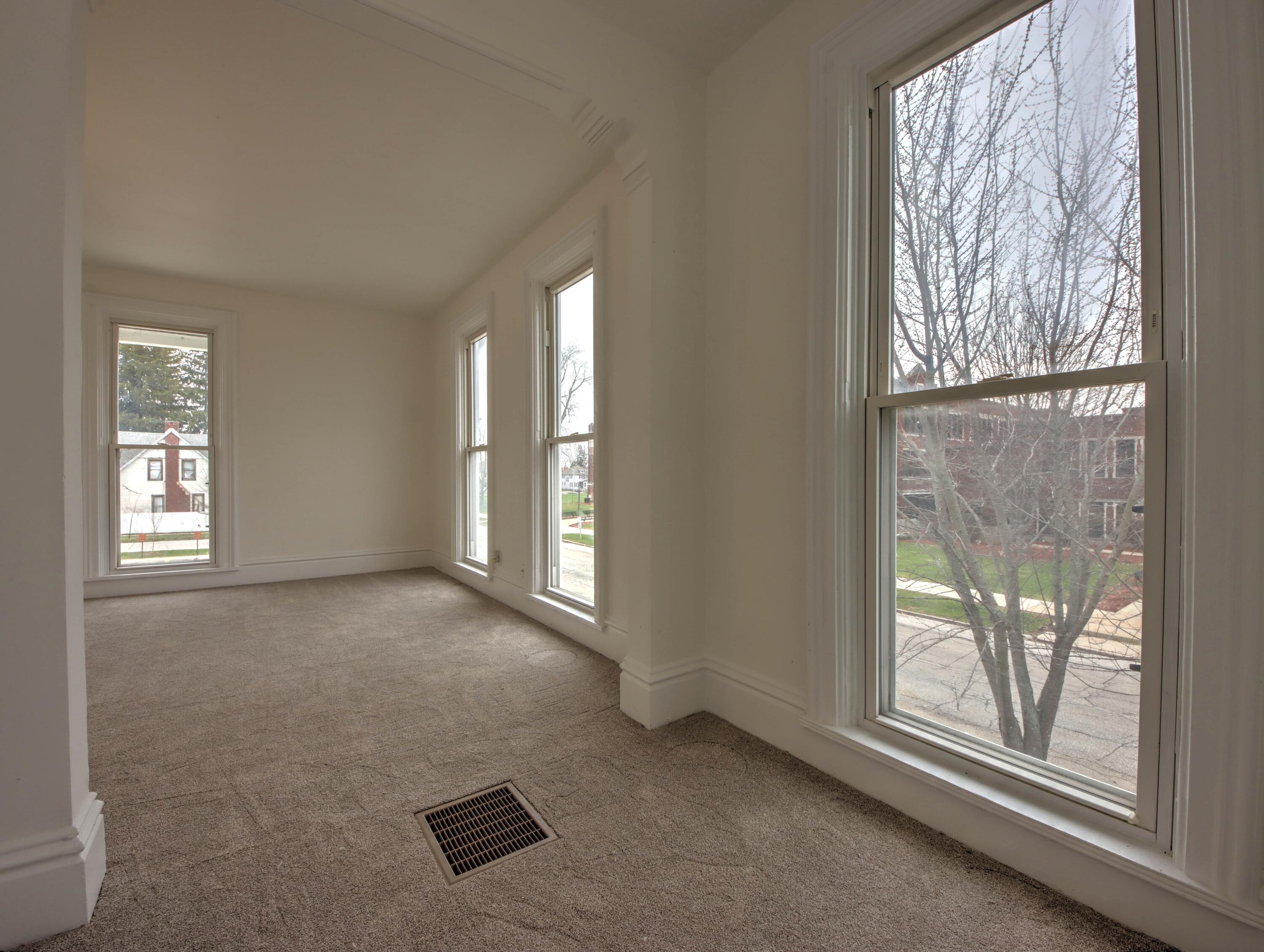1005 Harrison Street La Porte, IN 46350 - Photo 27 of 54 an empty room with windows and view of wooden floor