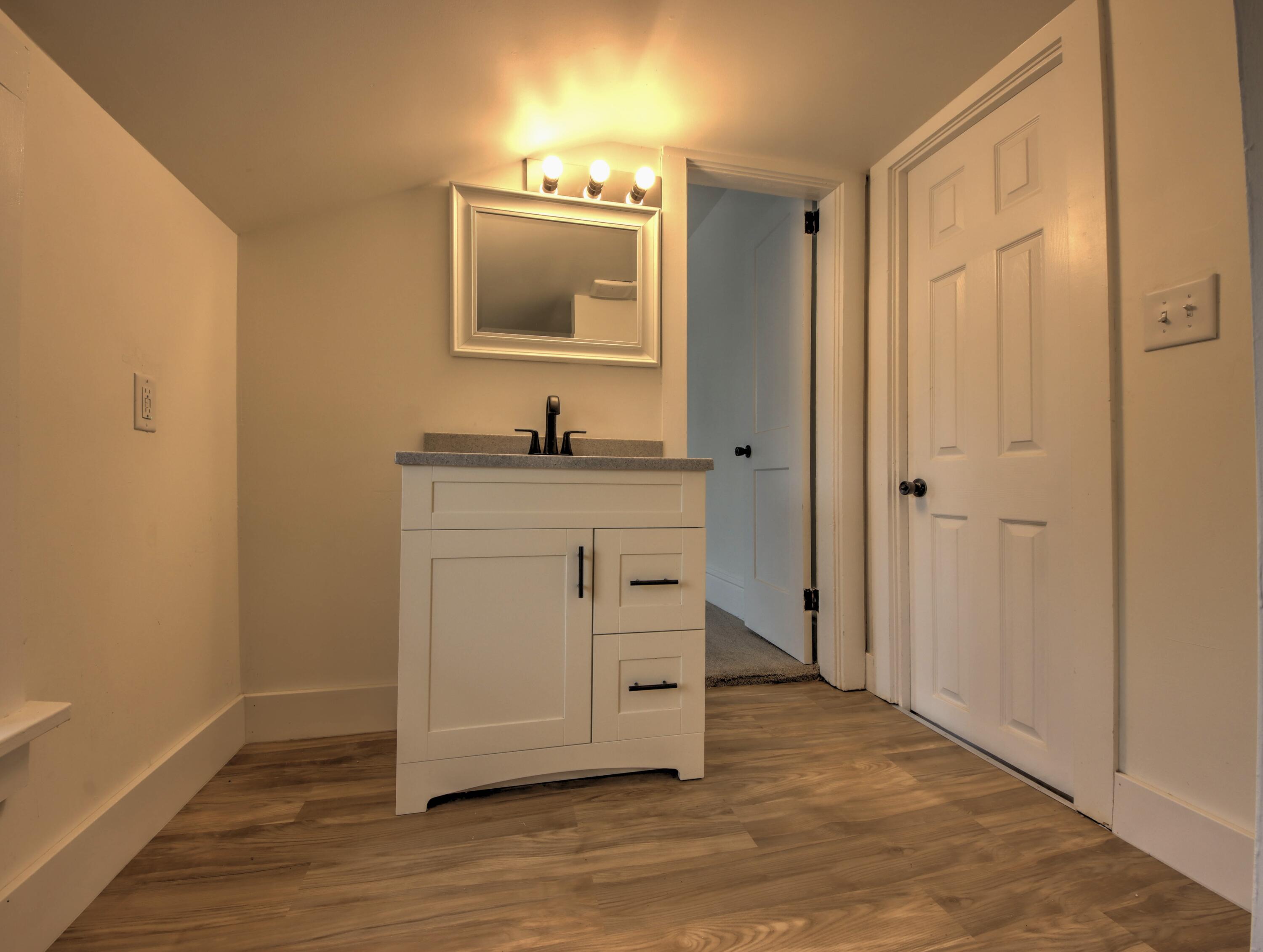 1005 Harrison Street La Porte, IN 46350 - Photo 30 of 54 a view of a bathroom with a sink and a mirror