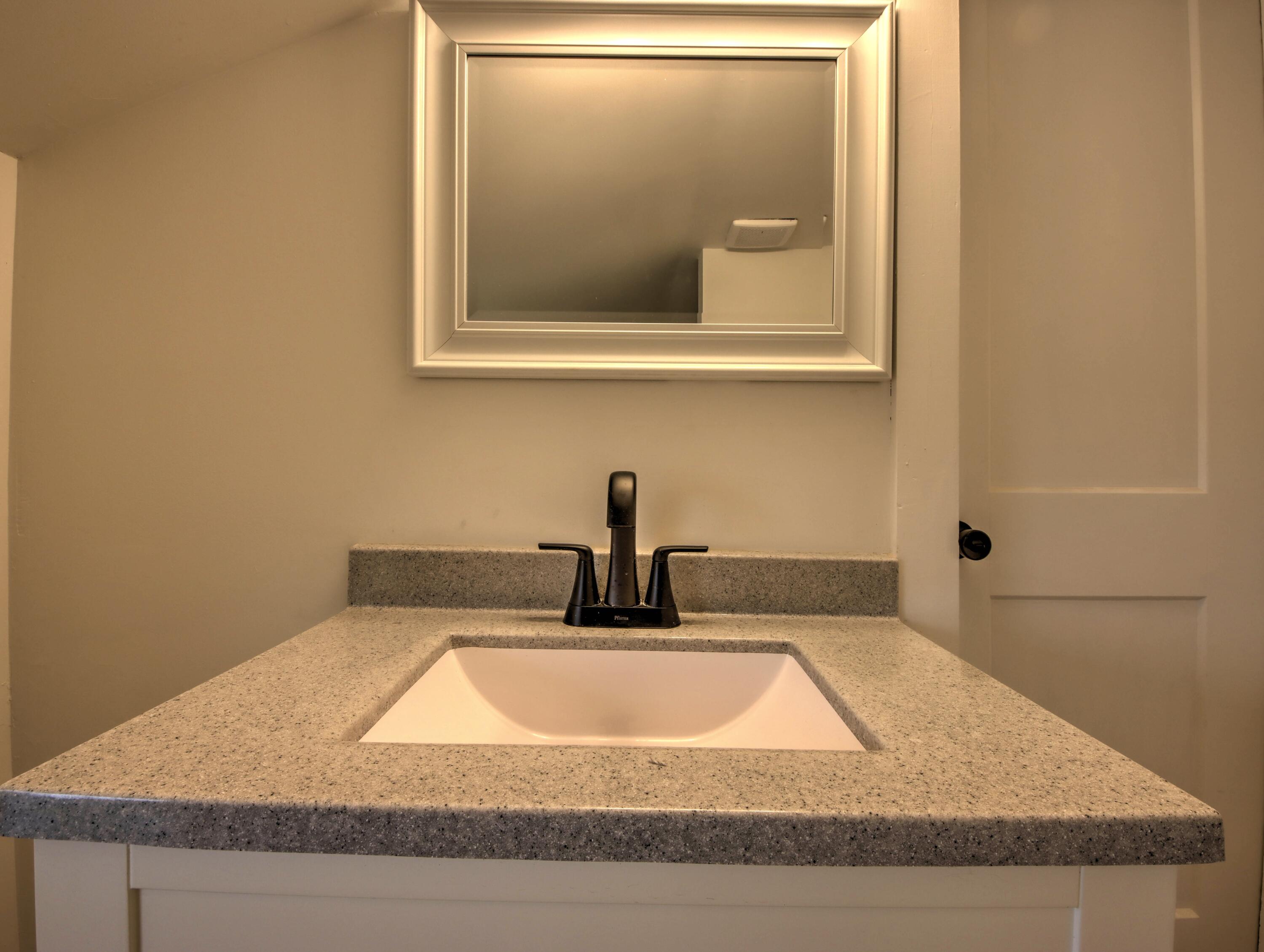 1005 Harrison Street La Porte, IN 46350 - Photo 31 of 54 a bathroom with a granite countertop sink and a mirror