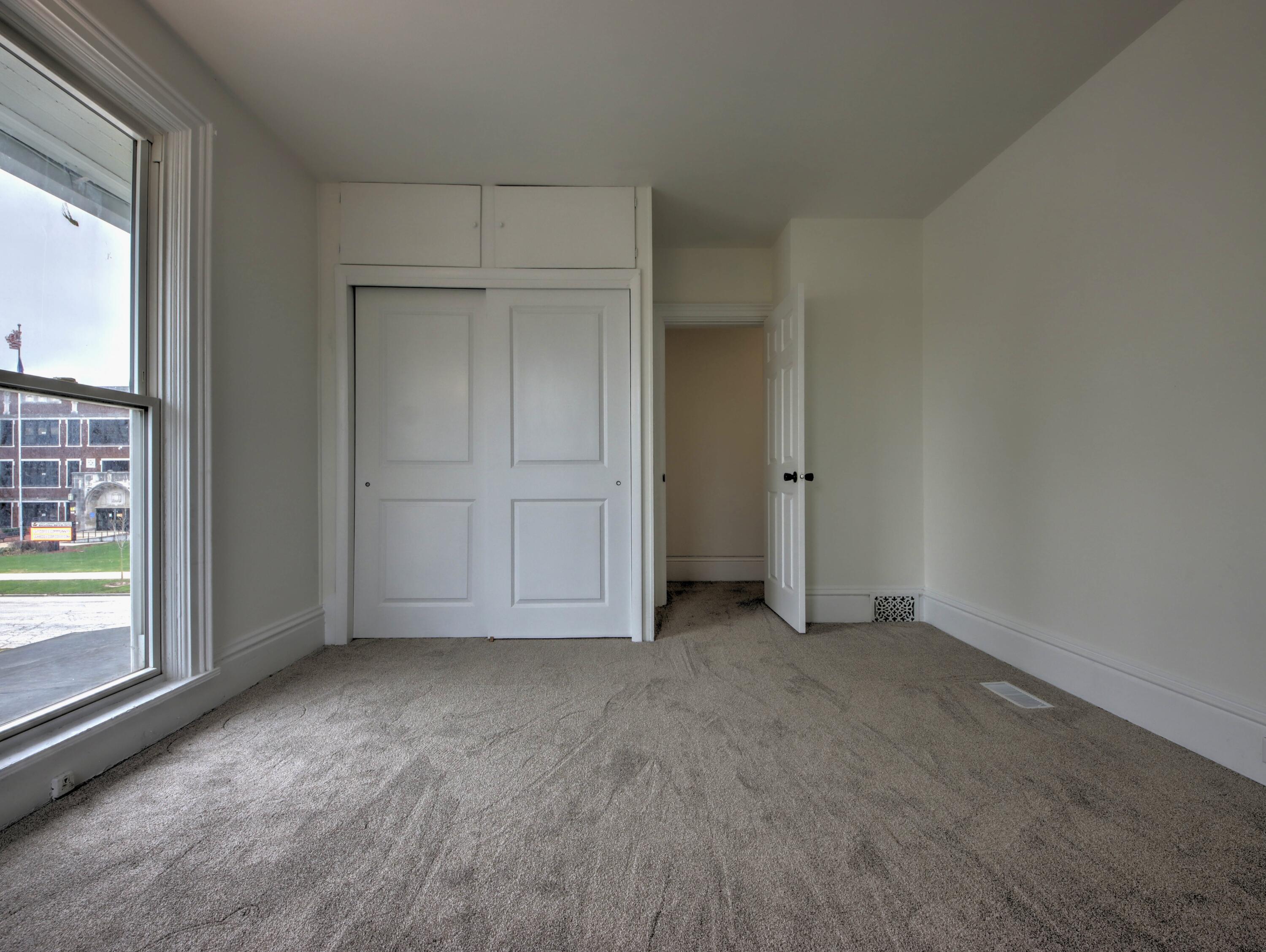 1005 Harrison Street La Porte, IN 46350 - Photo 33 of 54 an empty room with cabinet and windows
