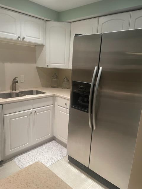 2000 Coco Plum Drive, Unit 1206 Marathon, FL 33050 - Photo 13 of 21 a kitchen with a refrigerator and white cabinets