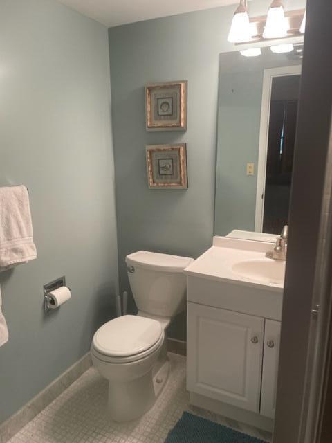 2000 Coco Plum Drive, Unit 1206 Marathon, FL 33050 - Photo 15 of 21 a bathroom with a toilet sink and mirror