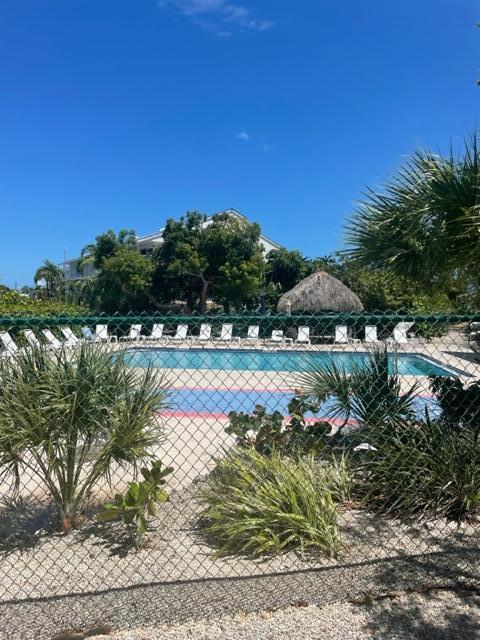 2000 Coco Plum Drive, Unit 1206 Marathon, FL 33050 - Photo 4 of 21 a view of a lake with a yard