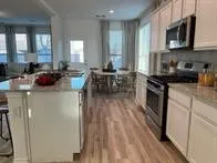 a kitchen with stove a sink and appliances