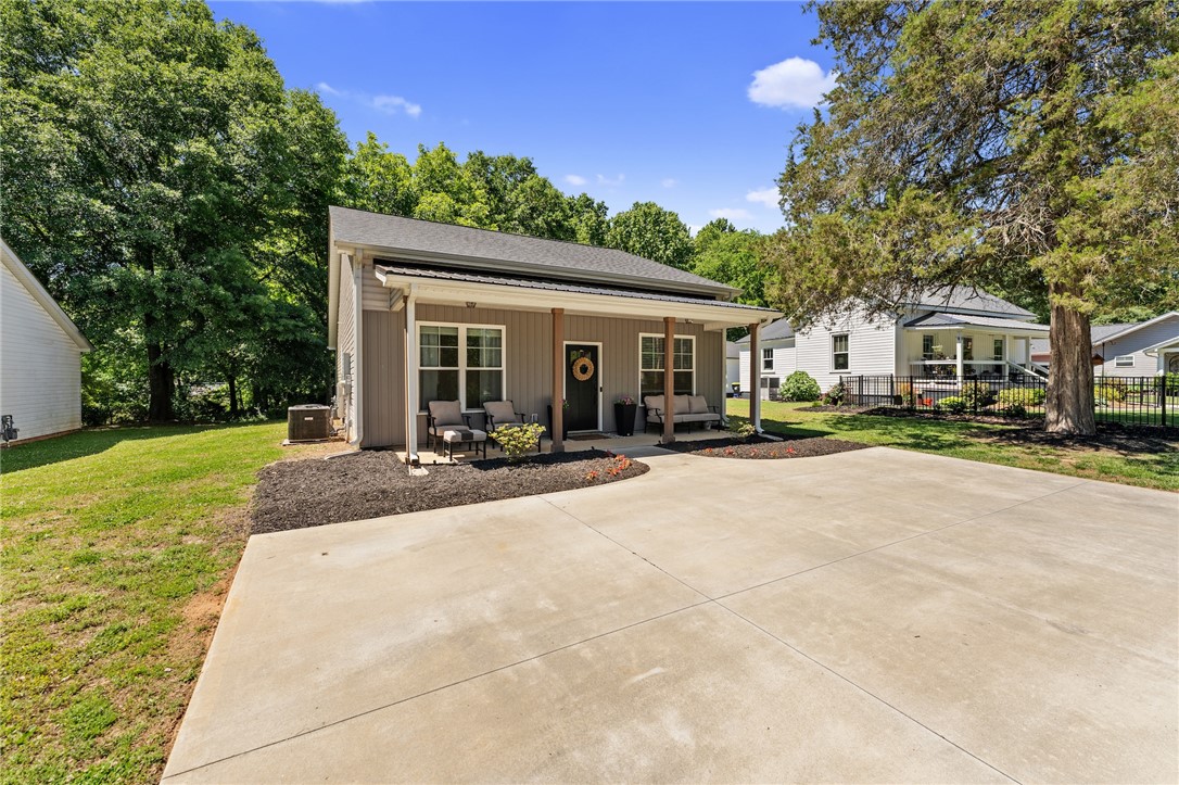 47 A Main Street Pelzer, SC 29669 - Photo 1 of 27 This charming home offers a welcoming front porch and ample outdoor space.