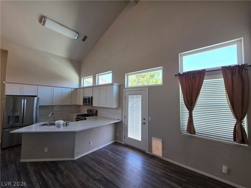 2275 Ramsgate Drive Henderson, NV 89074 - Photo 36 of 84 An airy kitchen features soaring vaulted ceilings and rich wood flooring.