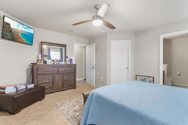 a bedroom with a bed and ceiling fan