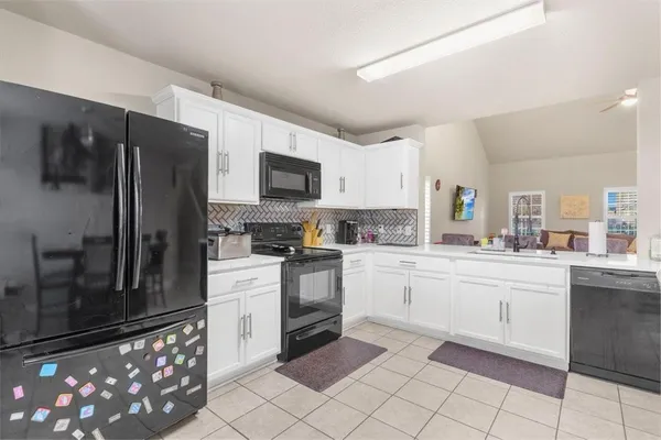 a kitchen with granite countertop cabinets and steel stainless steel appliances