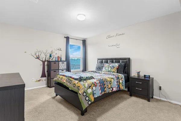 a bedroom with a bed and a night stand