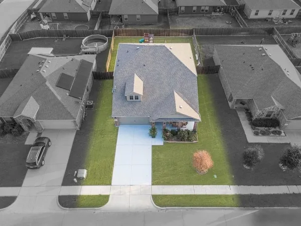 an aerial view of a house with a yard