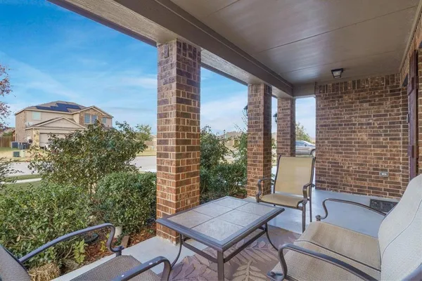 a view of balcony with a couple of couches and potted plants