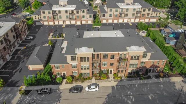 an aerial view of residential houses with outdoor space and river