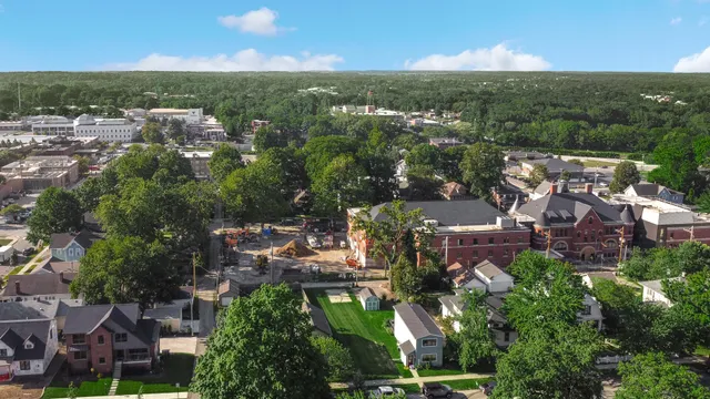 an aerial view of multiple houses with yard