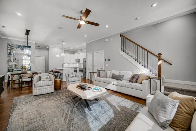 a living room with furniture a fireplace and a flat screen tv