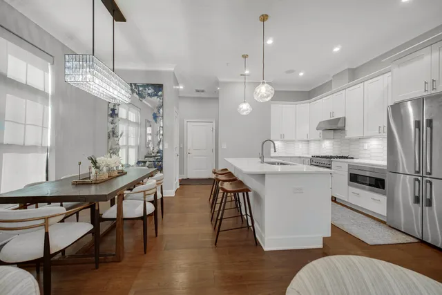 a kitchen with sink stove and wooden floor