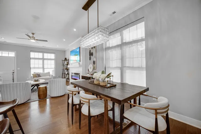 a living room with kitchen island furniture and a chandelier