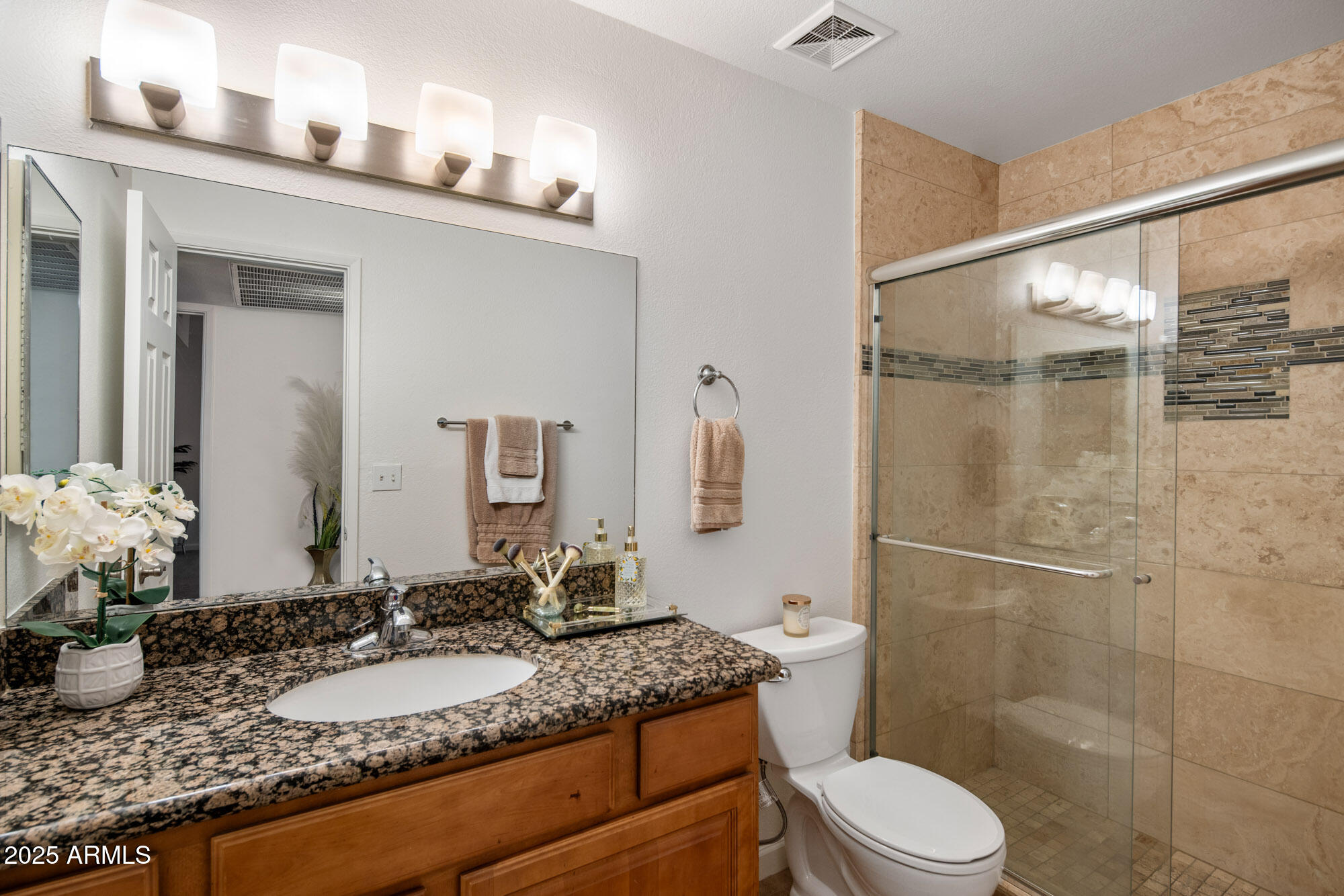 5877 North Granite Reef Road, Unit 2212 Scottsdale, AZ 85250 - Photo 11 of 16 a bathroom with a granite countertop sink mirror vanity and toilet
