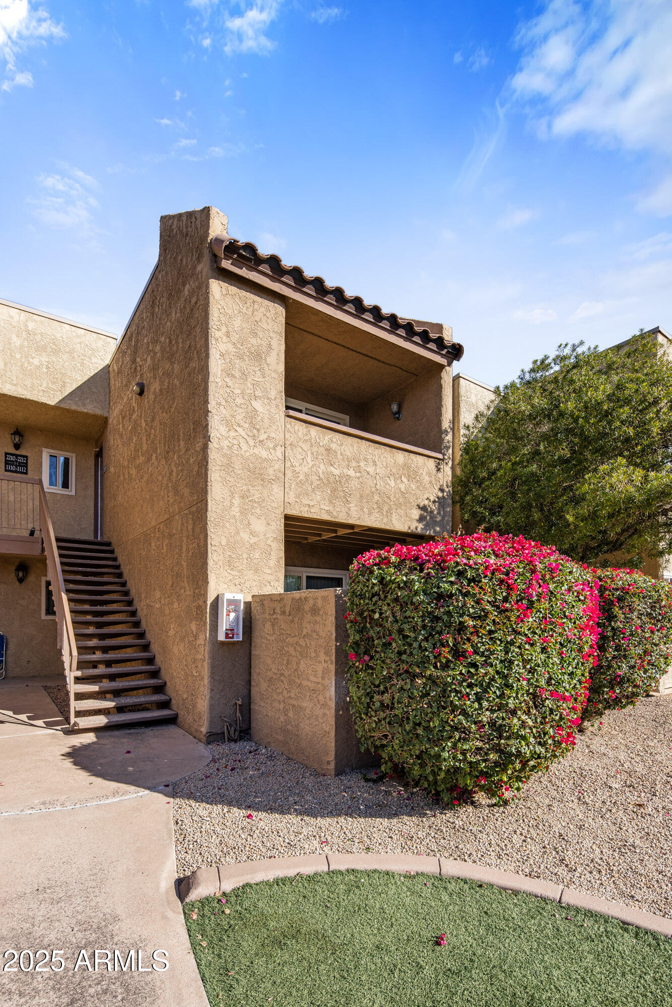 5877 North Granite Reef Road, Unit 2212 Scottsdale, AZ 85250 - Photo 12 of 16 a front view of a house with a garden