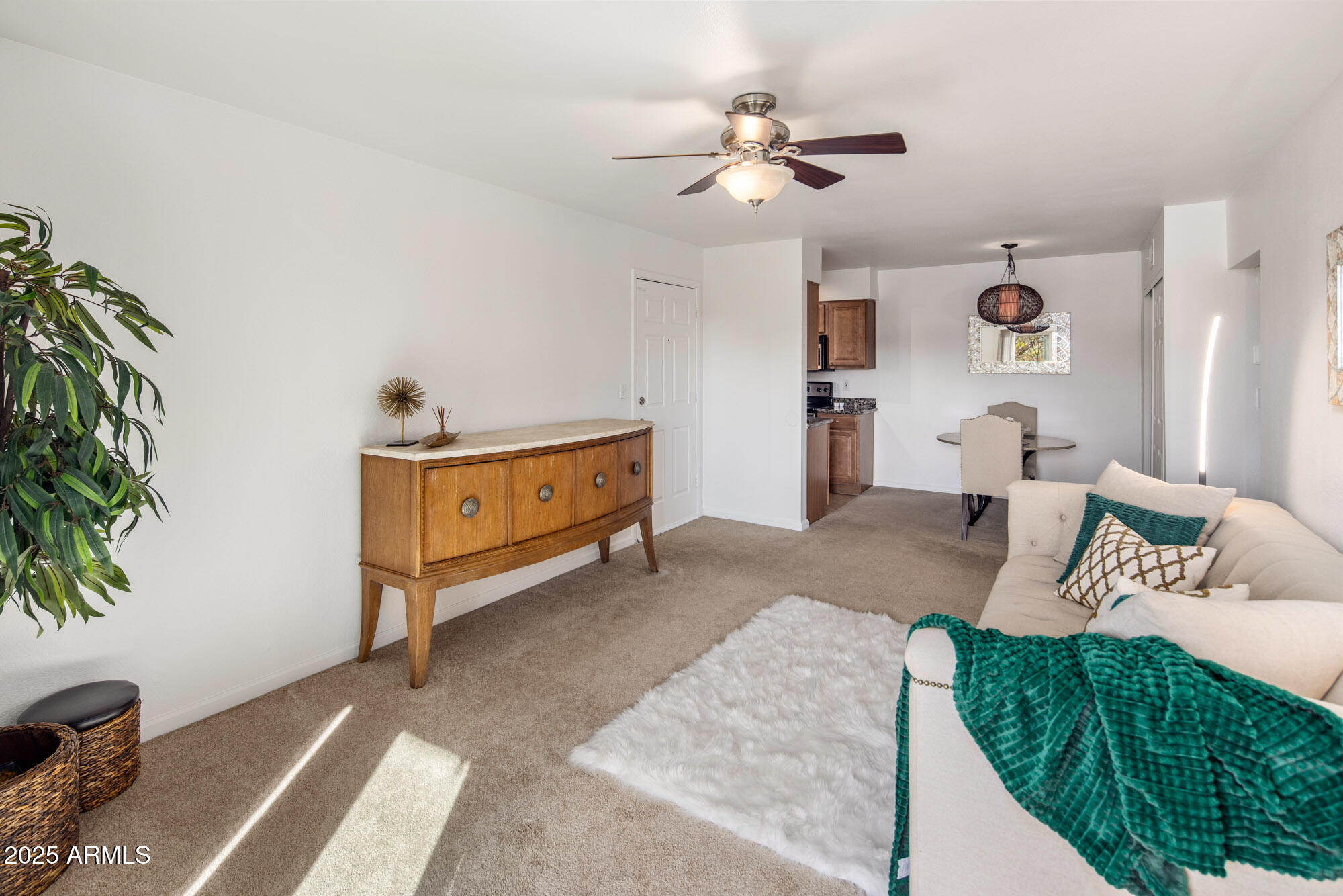 5877 North Granite Reef Road, Unit 2212 Scottsdale, AZ 85250 - Photo 3 of 16 a bedroom with a bed and a chandelier