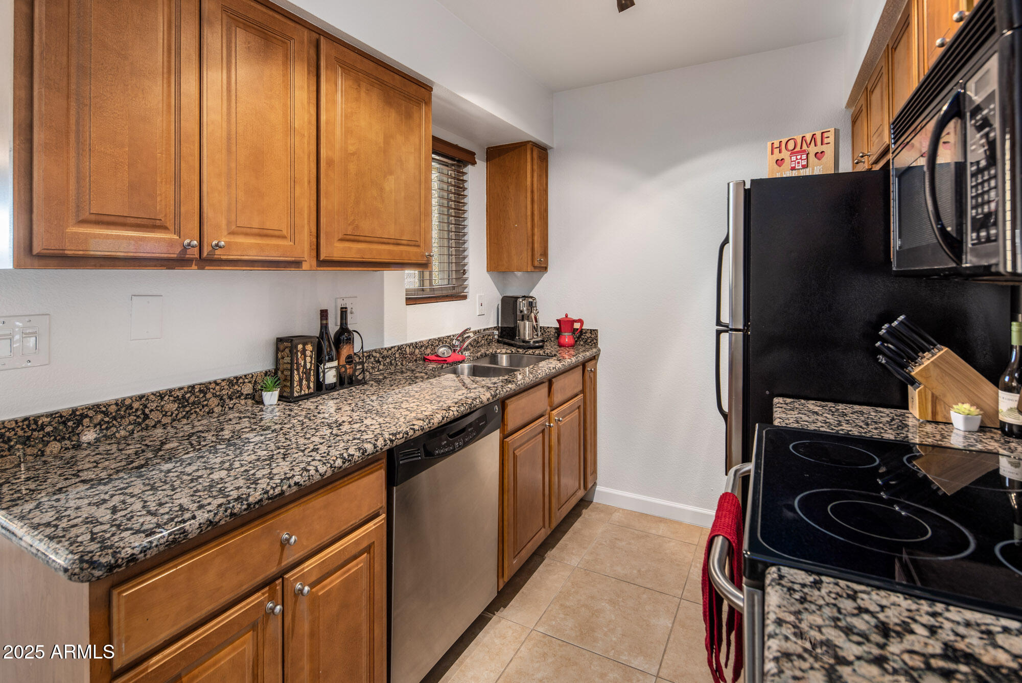 5877 North Granite Reef Road, Unit 2212 Scottsdale, AZ 85250 - Photo 5 of 16 a kitchen with stainless steel appliances granite countertop a sink stove and refrigerator