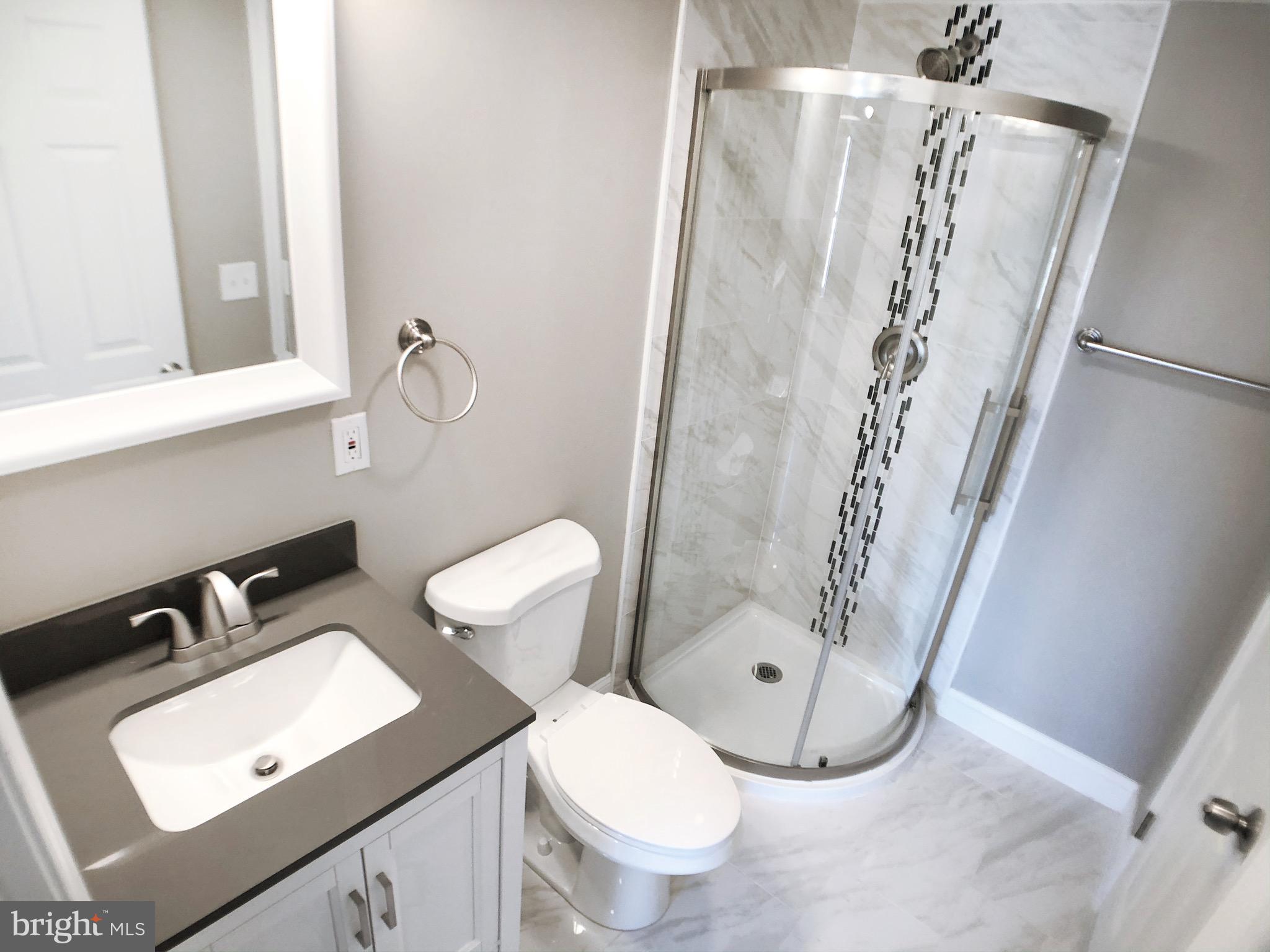 1111 Bayard Street Baltimore, MD 21223 - Photo 17 of 39 a bathroom with a toilet sink and shower