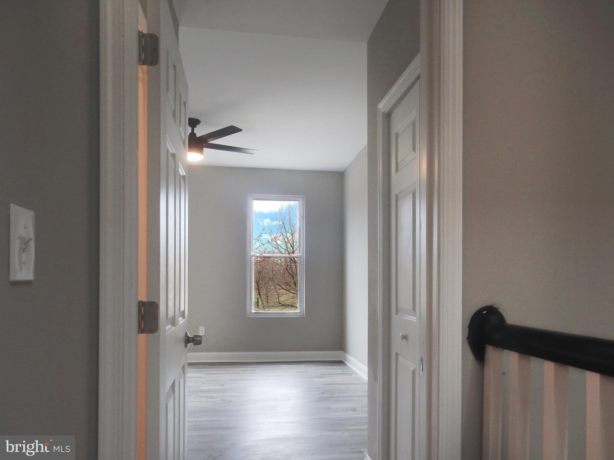 1111 Bayard Street Baltimore, MD 21223 - Photo 25 of 39 a view of hallway with windows and wooden floor