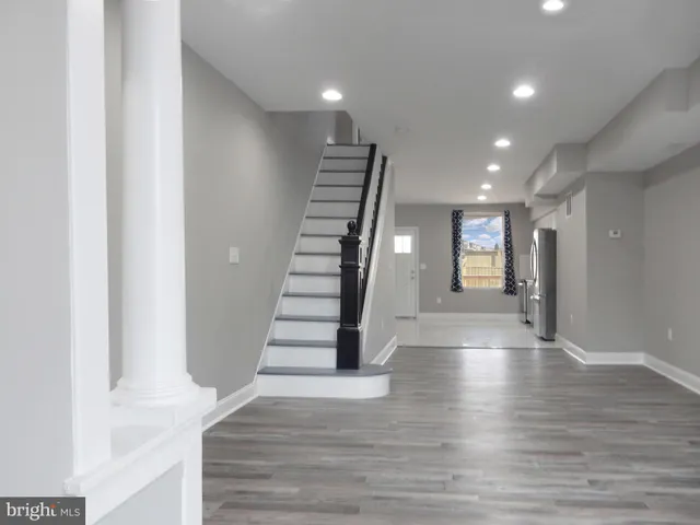 a view of an entryway with wooden floor