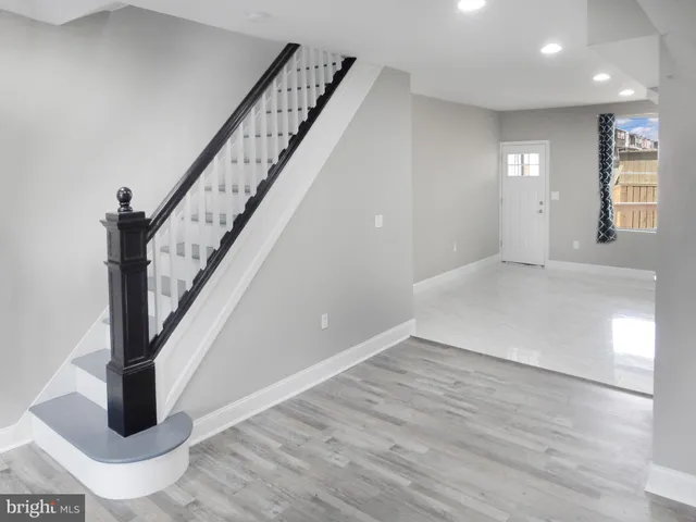 a view of an entryway with wooden floor