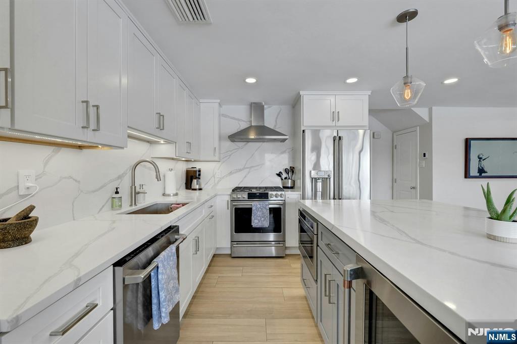 a large kitchen with stainless steel appliances lots of counter space sink and cabinets
